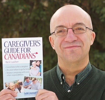Portrait of Rick Lauber holding his book "Caregiver's Guide For Canadians"