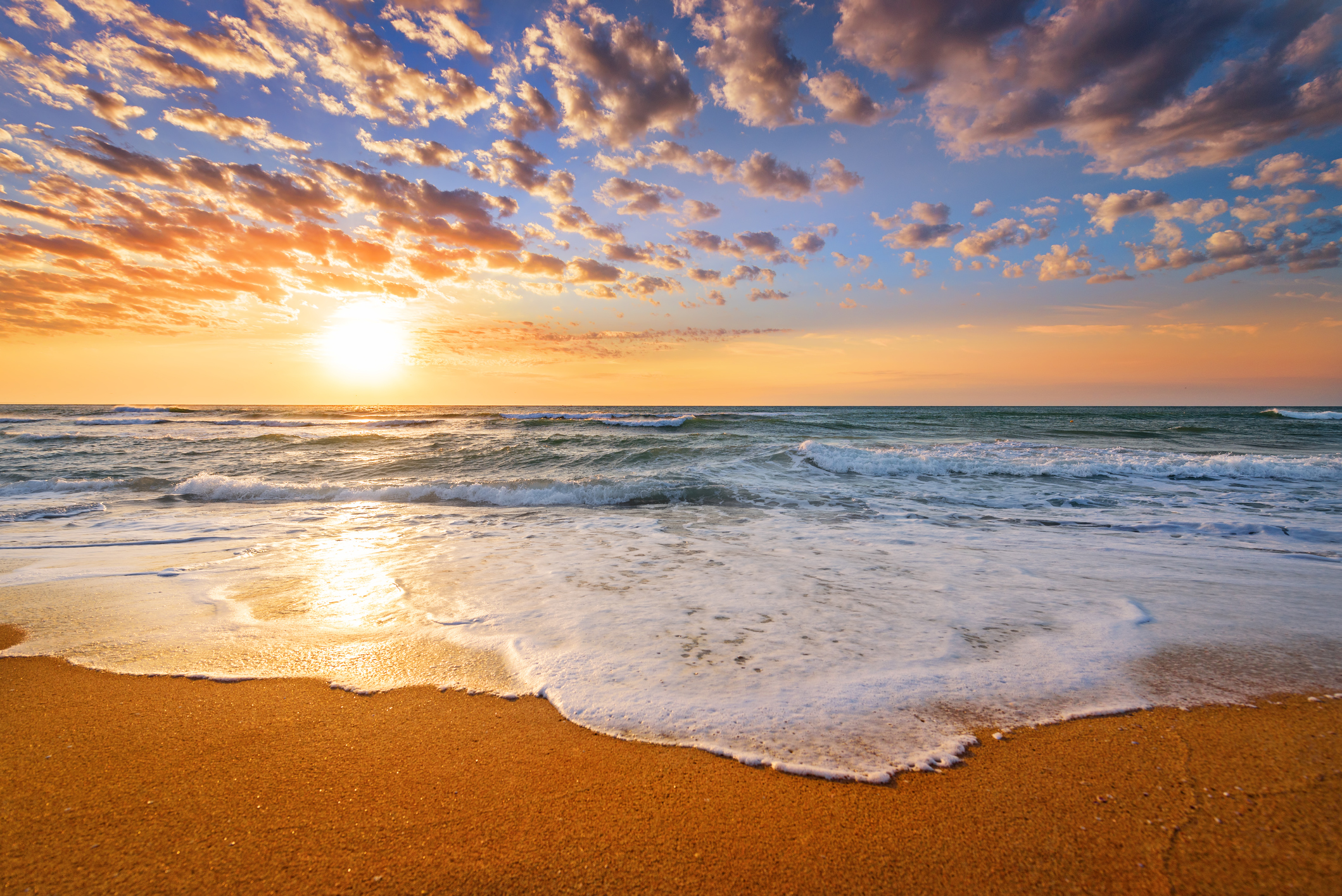 image of a sunrise over an ocean beach horizon