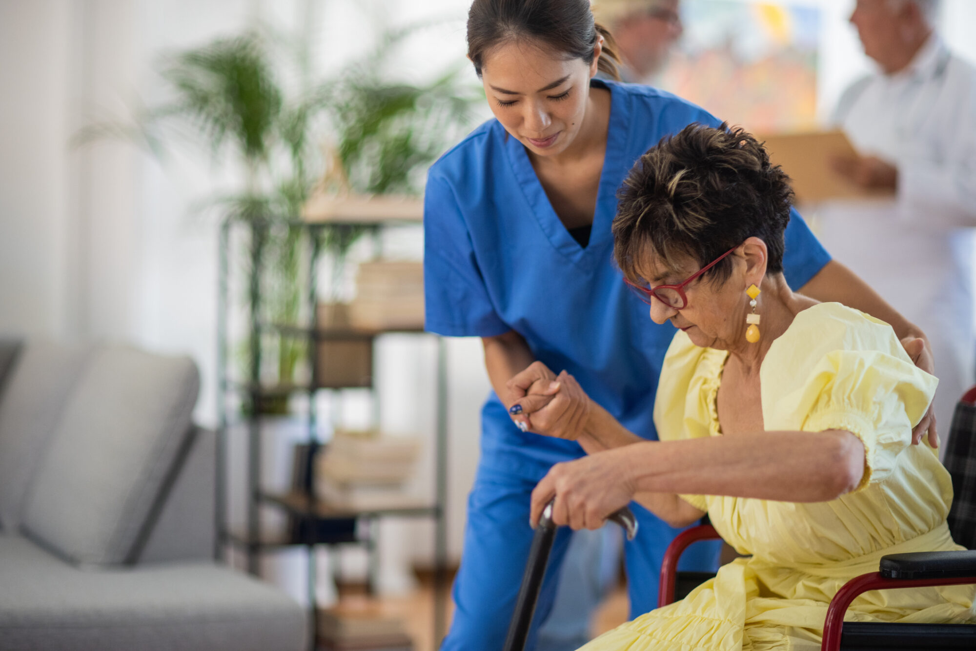 Home health care aide helping elderly woman